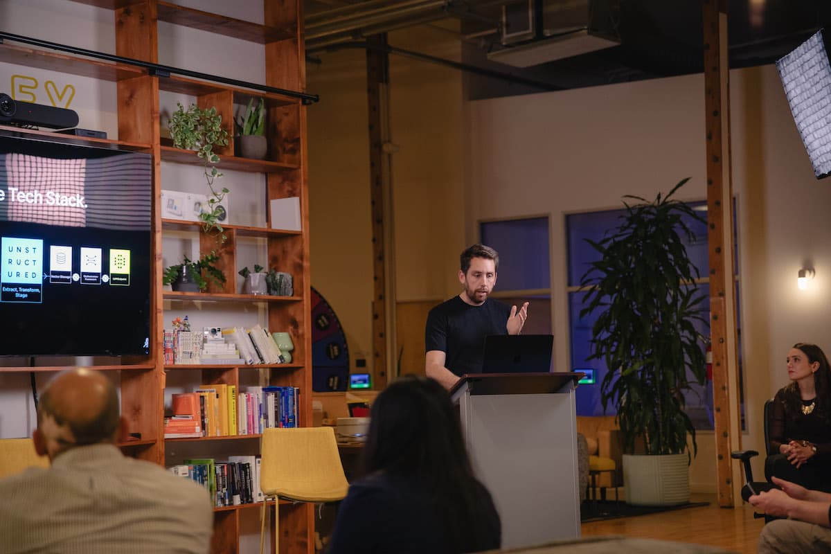 A speaker presenting at Thursday Nights in AI